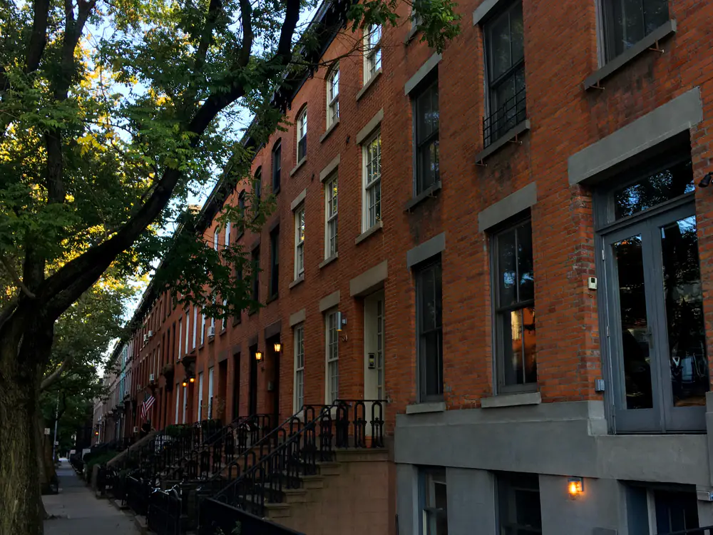 Row houses on Degraw Street, Carroll Gardens, with deep planted front gardens behind low fences